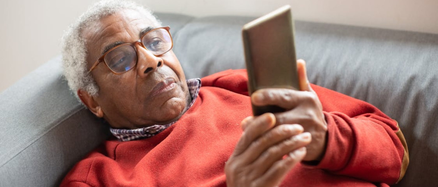 An older man looking at his phone