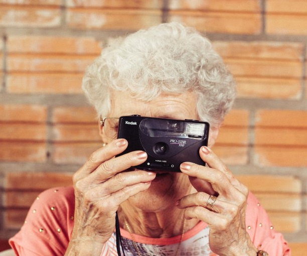 Older woman with an older film based plastic camera