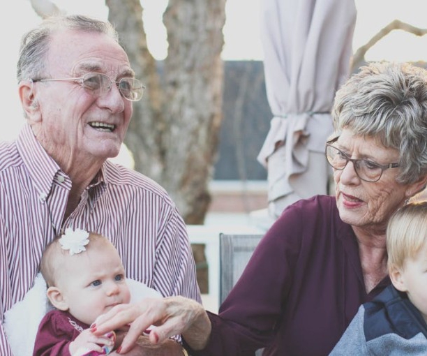 Two older people looking after very young grandchildren