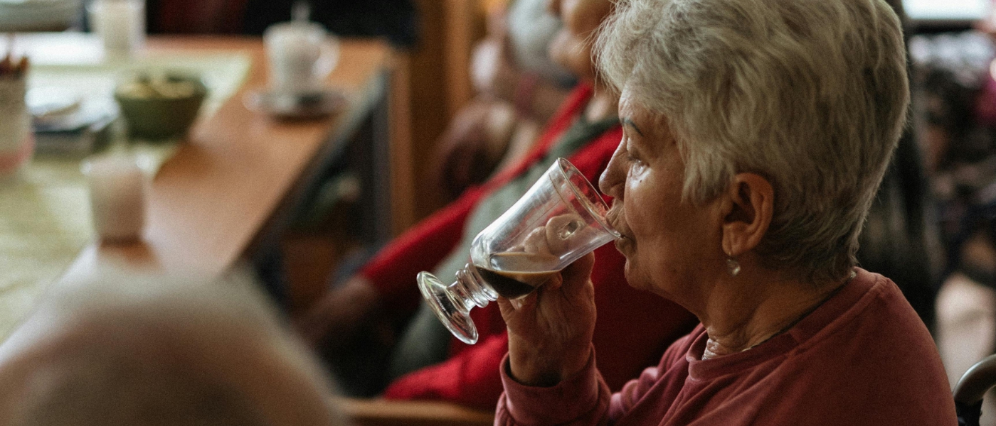 A woman sits at a table in a social club environment