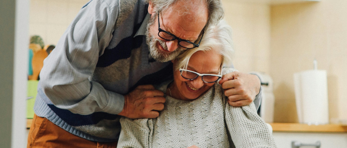 A happy older couple in their kitchen