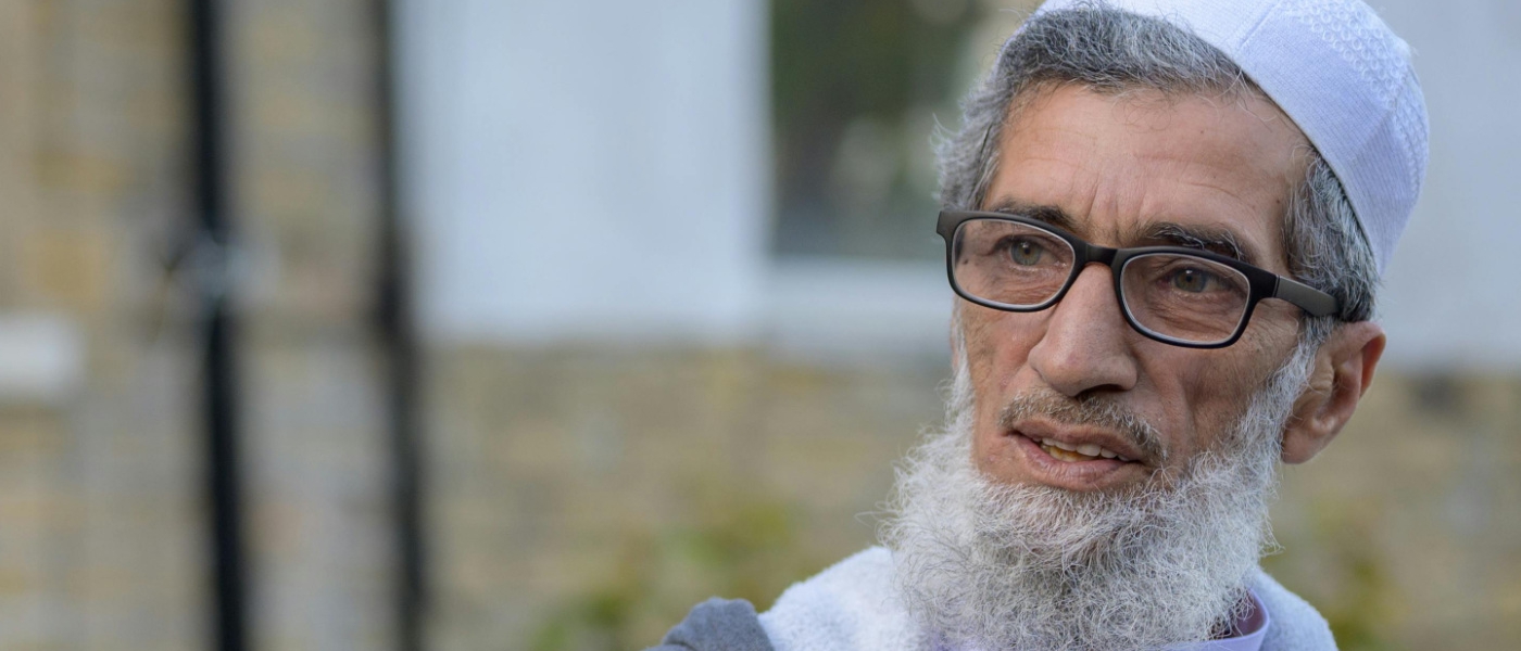 An older man wearing glasses and a white beard