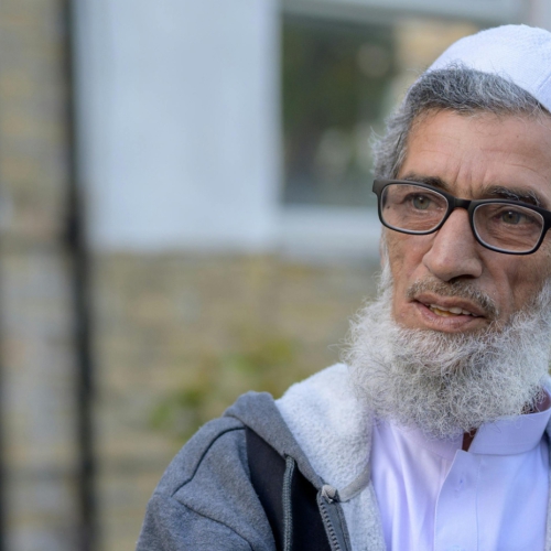 An older man wearing glasses and a white beard