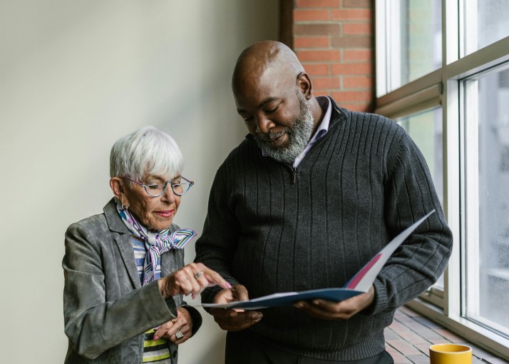 A man and woman viewing some paper documents