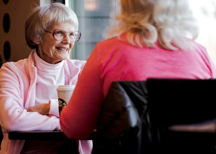 Two women talking at a table.