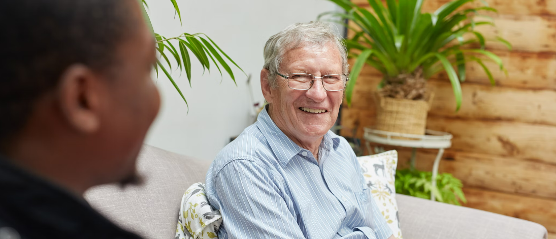 Older Man sitting by plants